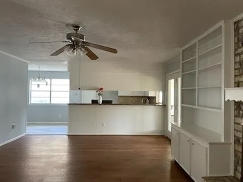 a view of a room with a window and a ceiling fan