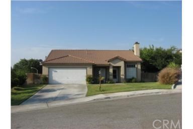 3389 Summers Court Riverside, CA 92501 - Photo 1 of 1 a front view of a house with a yard and garage