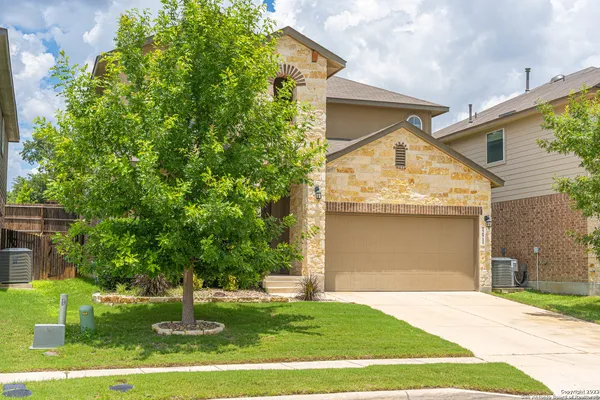 a front view of a house with a yard garage and outdoor seating