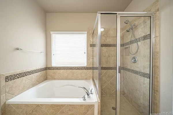 a bathroom with a tub and shower