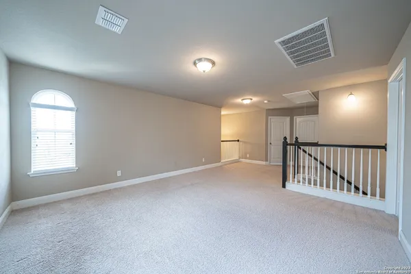 a view of an empty room and a window