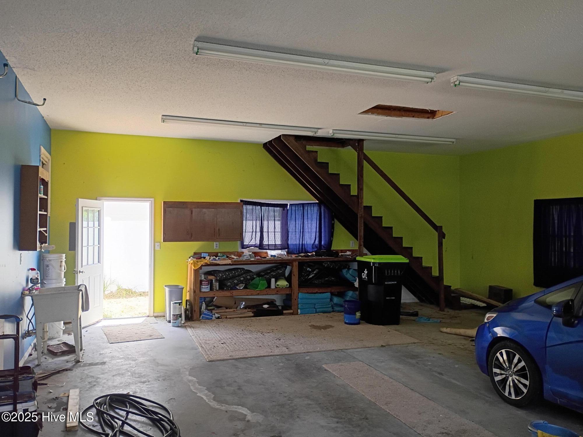 1099 Nautical Lane Southwest Calabash, NC 28467 - Photo 11 of 24 garage with stair access to more storage in the attic