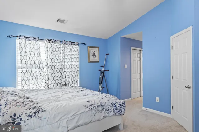 a bedroom with a large bed and a closet