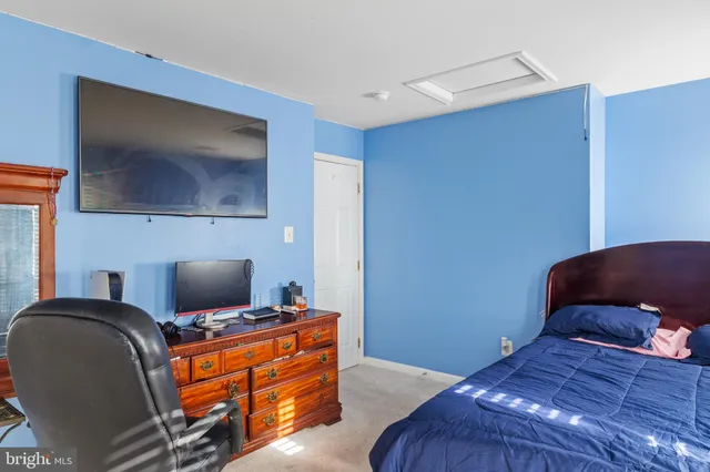 a bedroom with furniture and flat screen tv