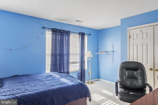 a bedroom with a bed and a chair