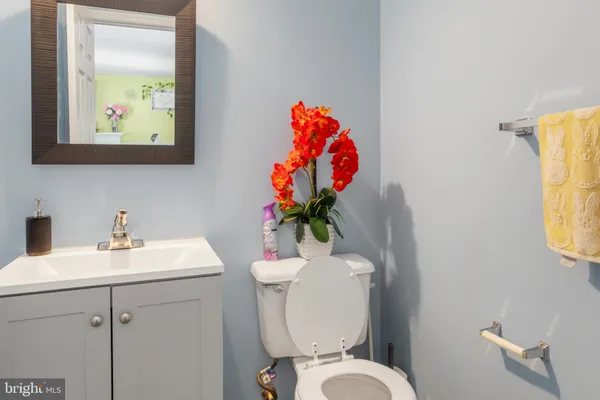 a bathroom with a toilet sink and mirror