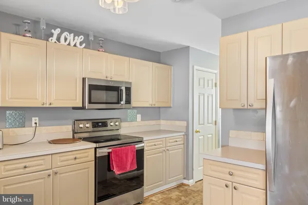 a kitchen with a refrigerator stove and sink