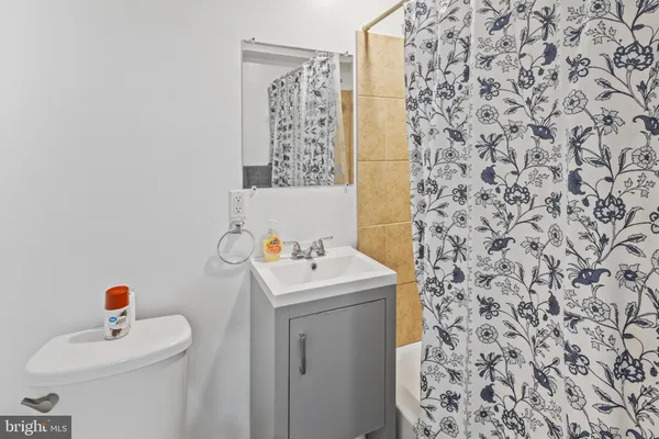a bathroom with a sink toilet and a mirror