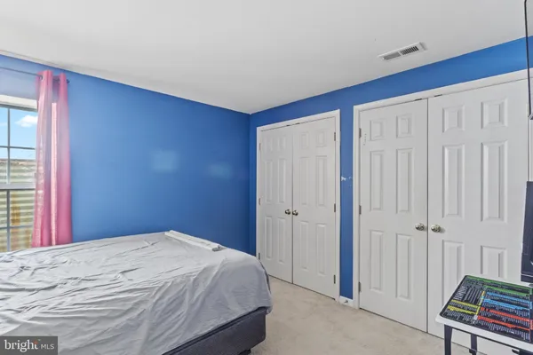 a bedroom with a bed and a chair