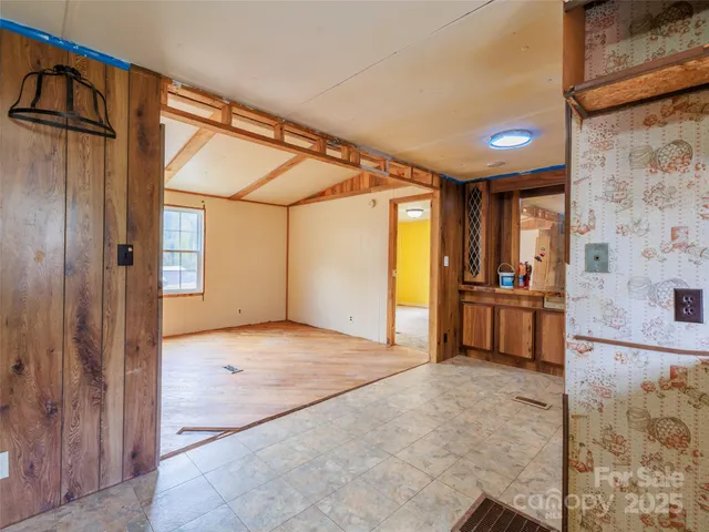a view of empty room with a kitchen