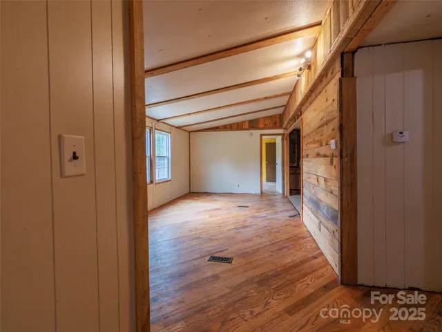 a view of empty room with a fireplace and windows