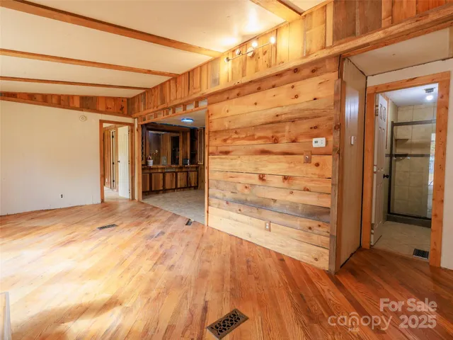 a view of empty room with wooden floor and cabinet