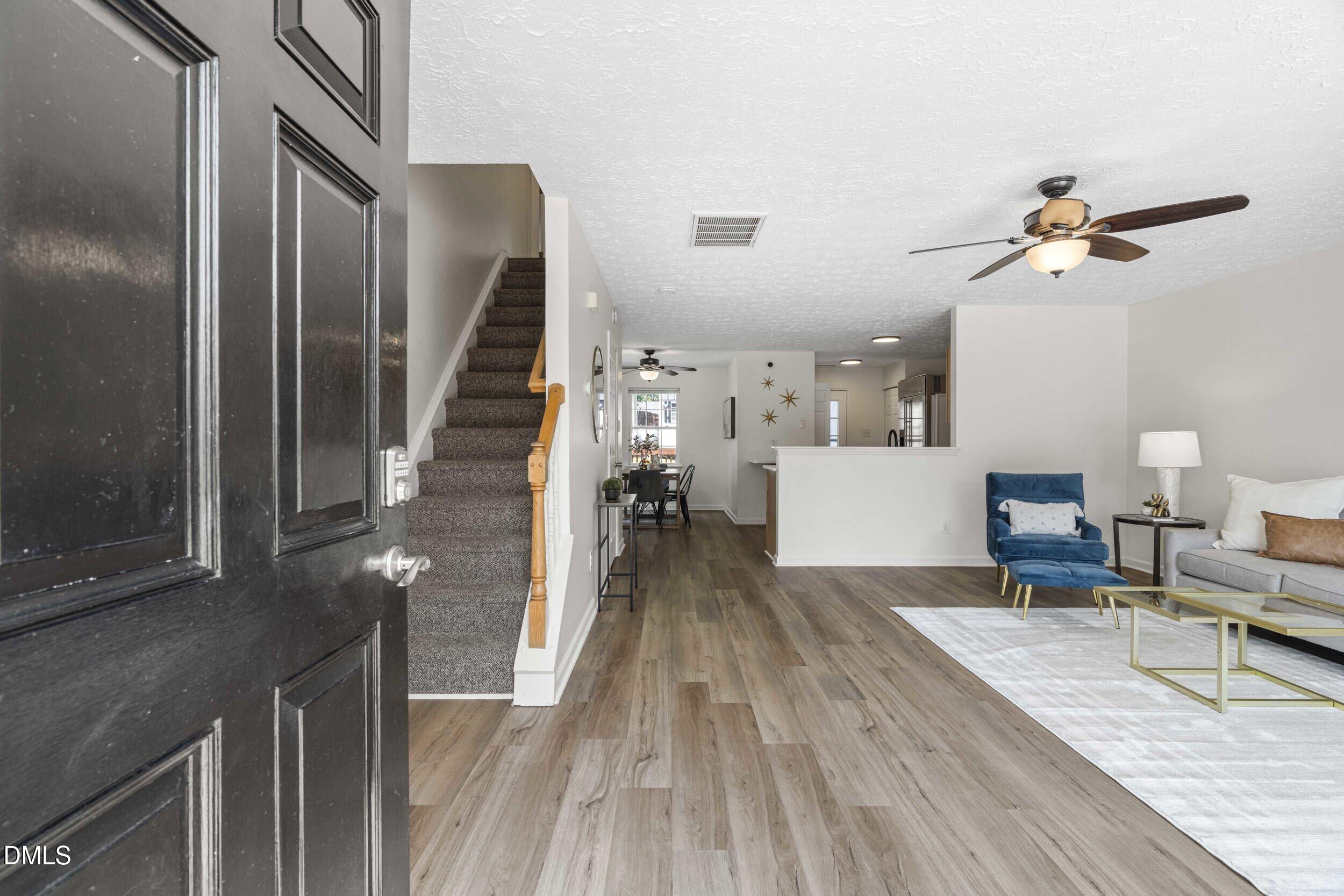 4121 Tensity Drive Raleigh, NC 27604 - Photo 34 of 34 Entry opens to a bright, open floor plan with wood-look flooring throughout