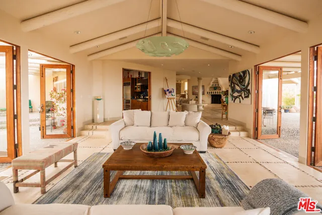 a dining room filled with furniture and a chandelier