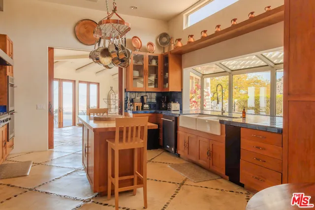 a living room with fireplace furniture and a floor to ceiling window