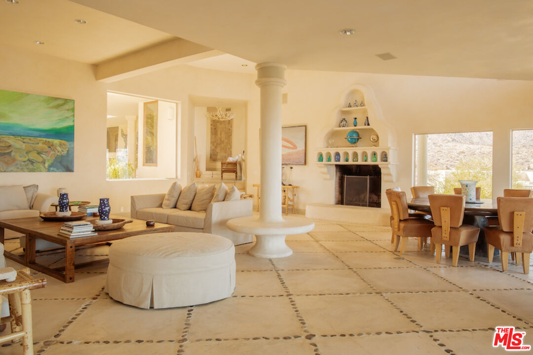 57425 Palm Seco Circle Mountain Center, CA 92561 - Photo 20 of 61 a living room with fireplace furniture and a floor to ceiling window