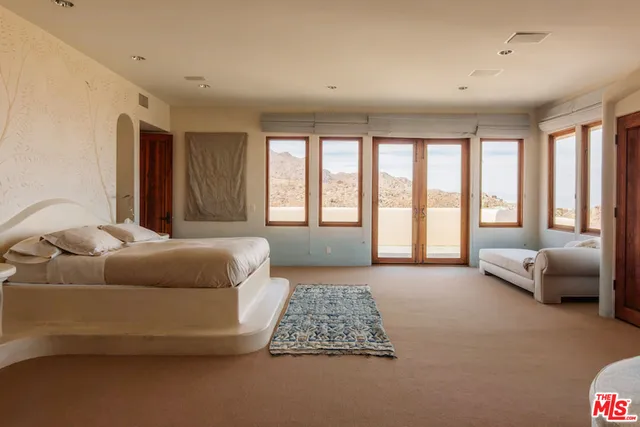 a bedroom with a large bed and a couch