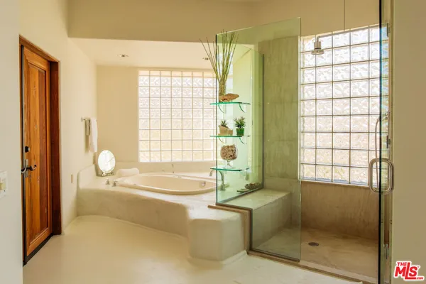 a bathroom with a bathtub and a window