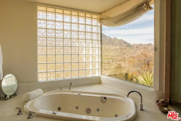a bathroom with a tub and a mirror