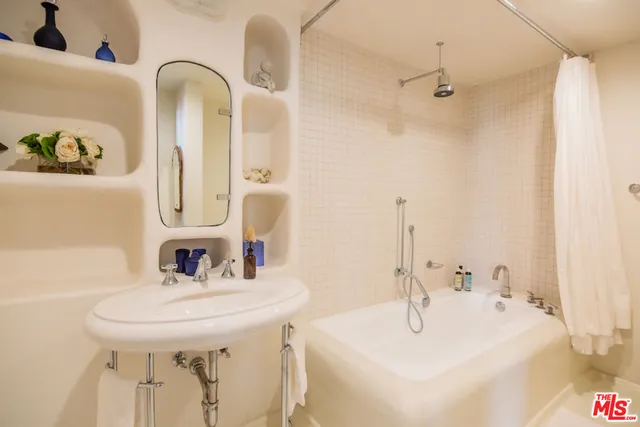 a bathroom with a tub and shower