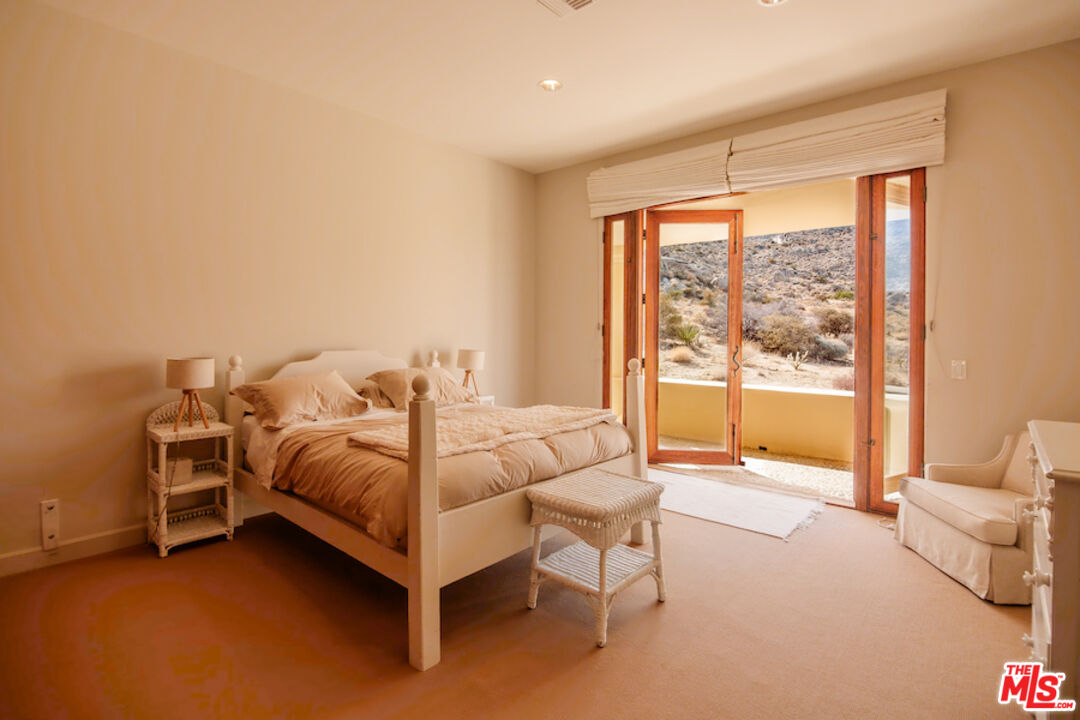 57425 Palm Seco Circle Mountain Center, CA 92561 - Photo 35 of 61 a spacious bedroom with a bed and a large window