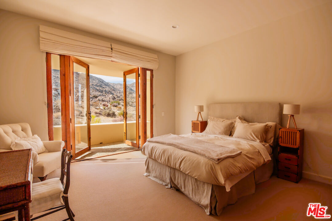 57425 Palm Seco Circle Mountain Center, CA 92561 - Photo 36 of 61 a bedroom with a bed and large window