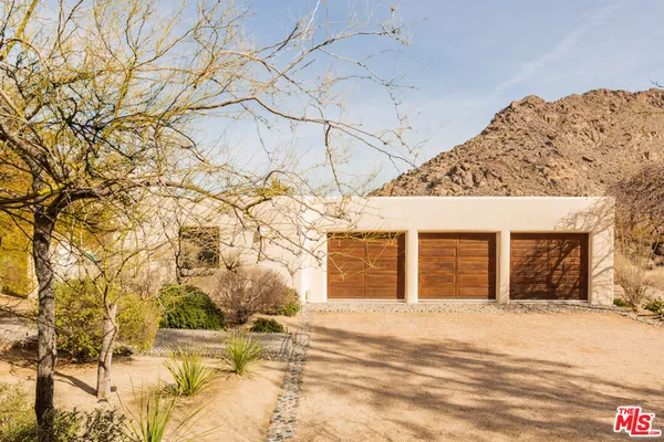 a view of a house with a snow in the background