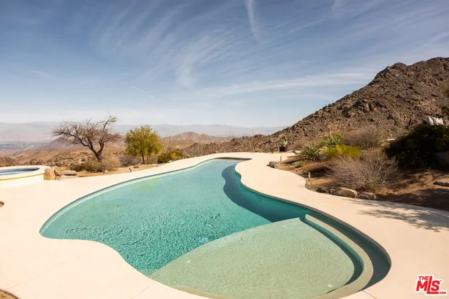 a kitchen with kitchen island a stove and a sink