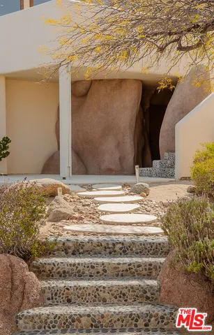 a living room with furniture gym equipment and a large window