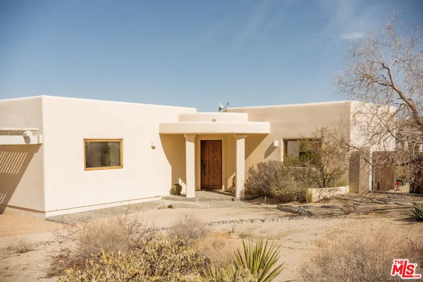 a bedroom with a large bed and a large window with outer view