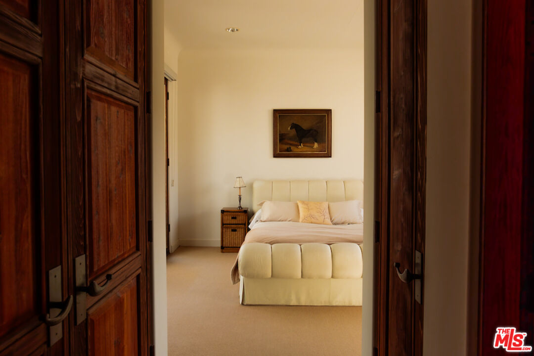 57425 Palm Seco Circle Mountain Center, CA 92561 - Photo 47 of 61 a bedroom with a bed and a wall painting