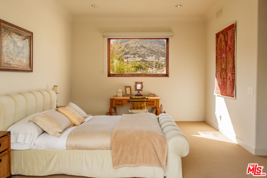 57425 Palm Seco Circle Mountain Center, CA 92561 - Photo 48 of 61 a bedroom with a bed and a window