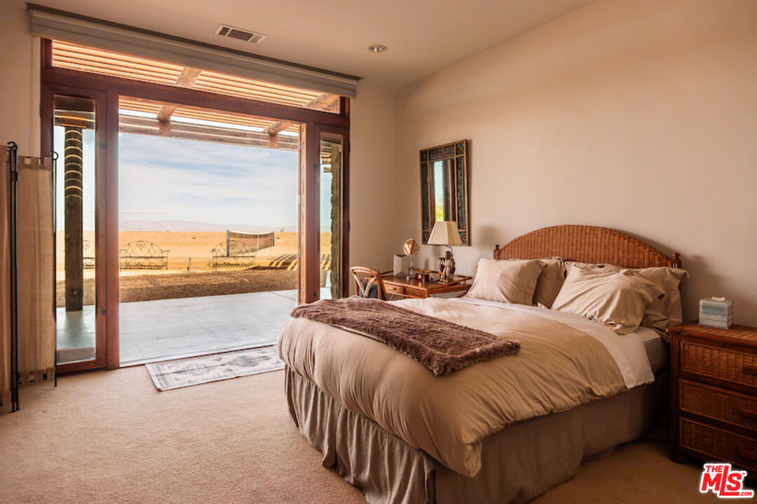 57425 Palm Seco Circle Mountain Center, CA 92561 - Photo 53 of 61 a bedroom with a bed and large window