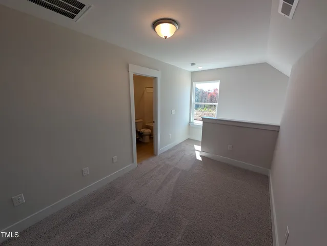 an empty room with an entrance to other room