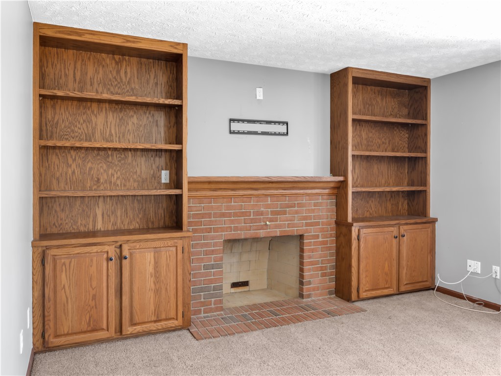 25 Callaway Springboro, OH 45066 - Photo 14 of 51 This inviting room features a classic brick fireplace flanked by custom built-in shelving.