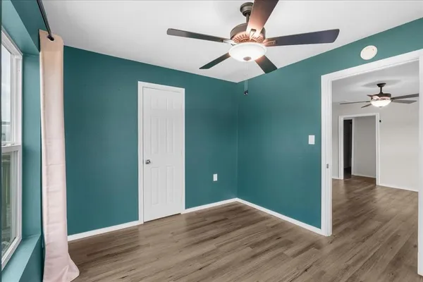 wooden floor in an empty room with a window