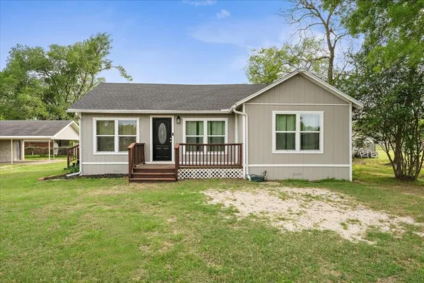 a house that has a big yard in front of it