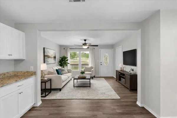a living room with furniture and a flat screen tv