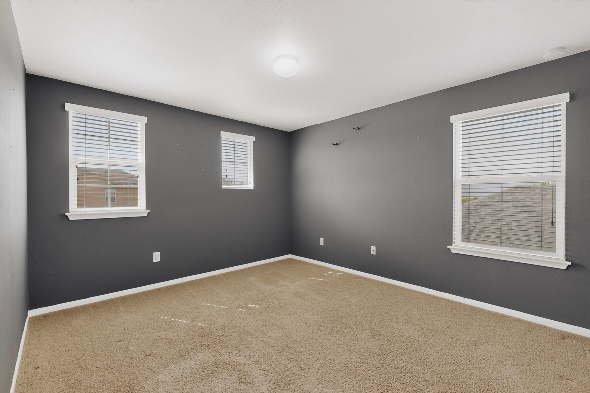 14513 Esker Road Manor, TX 78653 - Photo 19 of 38 A versatile space offering plentiful natural light and soft carpeting, perfect for a private retreat.