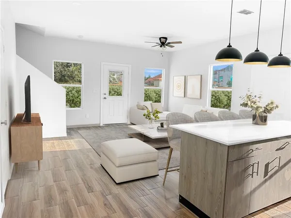 a spacious bedroom with a bed a window and dresser