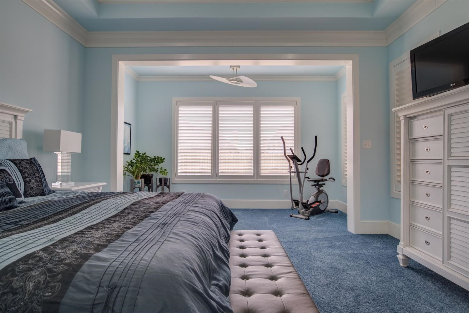 4002 113th Street Lubbock, TX 79423 - Photo 22 of 50 a spacious bedroom with a bed and flat screen tv