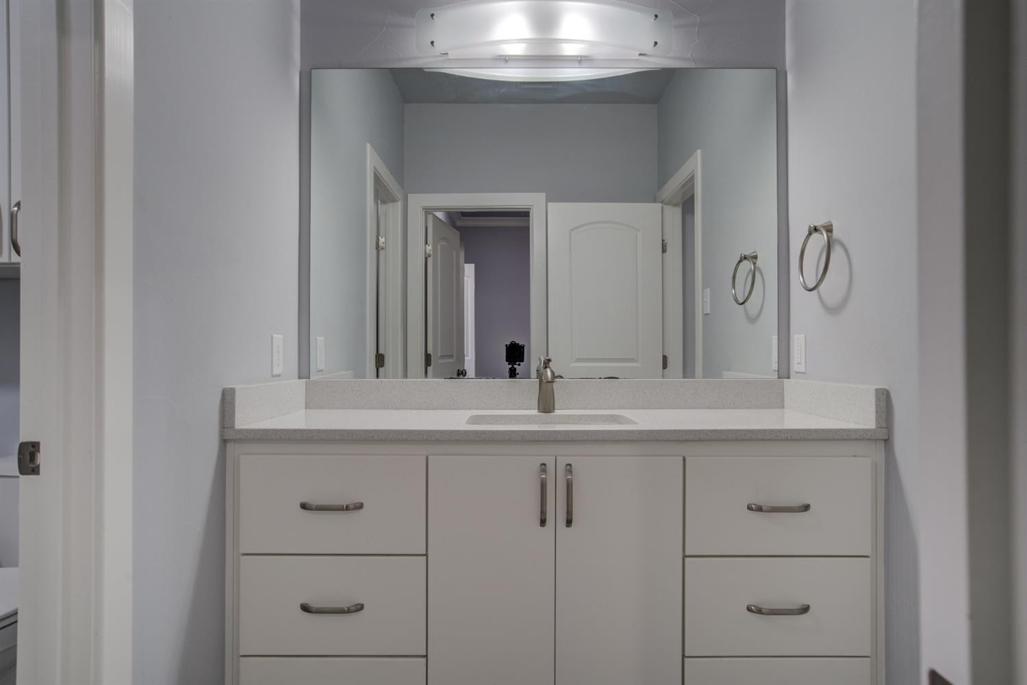 4002 113th Street Lubbock, TX 79423 - Photo 37 of 50 a bathroom with a sink and a mirror