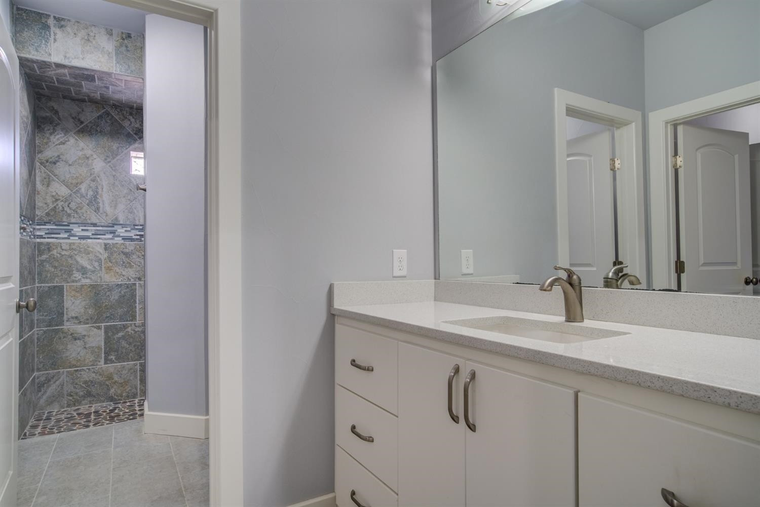 4002 113th Street Lubbock, TX 79423 - Photo 38 of 50 a bathroom with a sink and a mirror