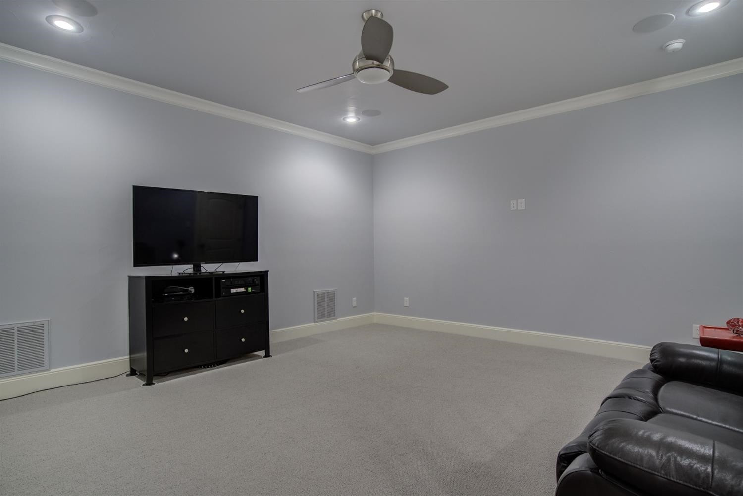 4002 113th Street Lubbock, TX 79423 - Photo 40 of 50 a living room with furniture and a flat screen tv