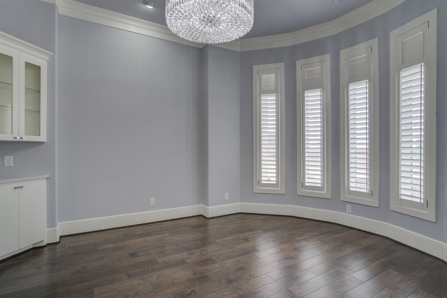 4002 113th Street Lubbock, TX 79423 - Photo 5 of 50 an empty room with wooden floor and windows