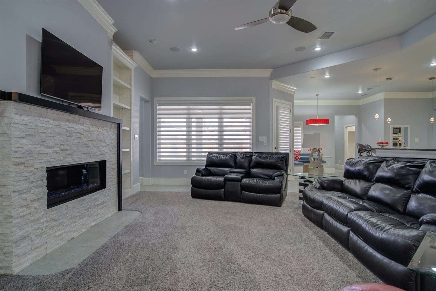 4002 113th Street Lubbock, TX 79423 - Photo 7 of 50 a living room with furniture a flat screen tv and a fireplace