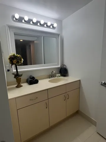 a white toilet sitting next to a white sink