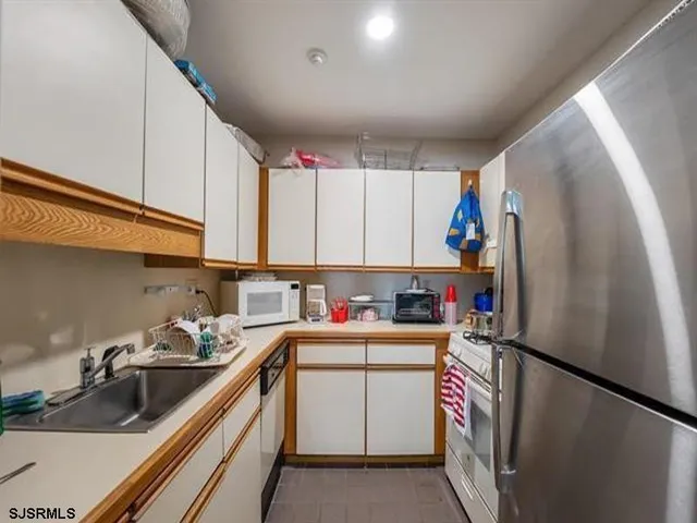 a view of a house with a yard patio and fire pit