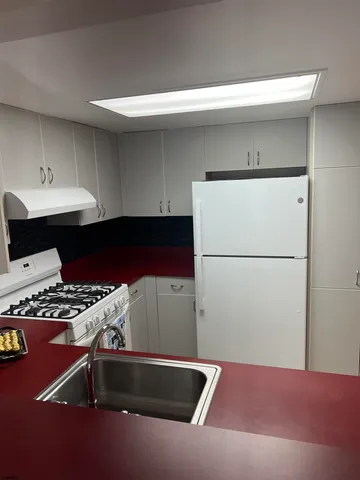 a room with a wooden floor and white walls