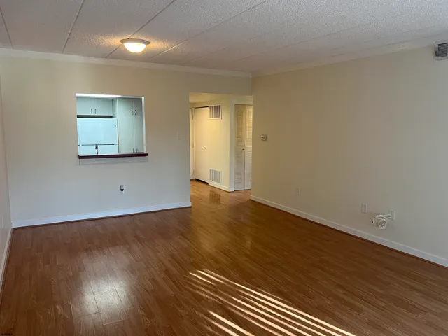 a view of a balcony with wooden floor and fence